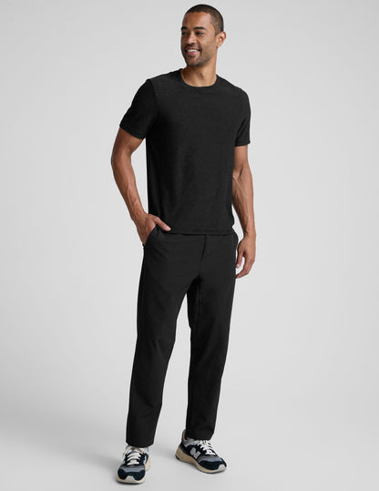 Man wearing black Dynamic Men's Straight Leg Pant, featuring a relaxed straight-leg fit and side pockets.
