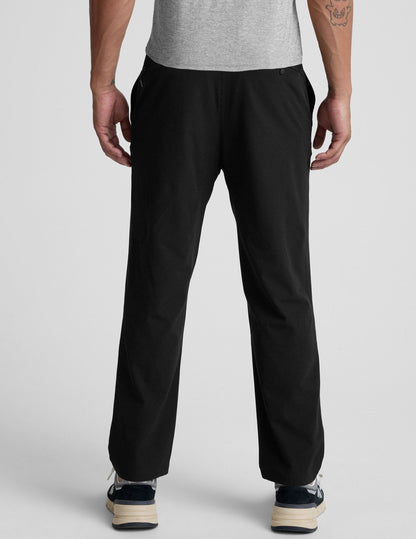 Rear view of the black Dynamic Men's Straight Leg Pant featuring a relaxed fit, straight leg, and elasticated waistband.