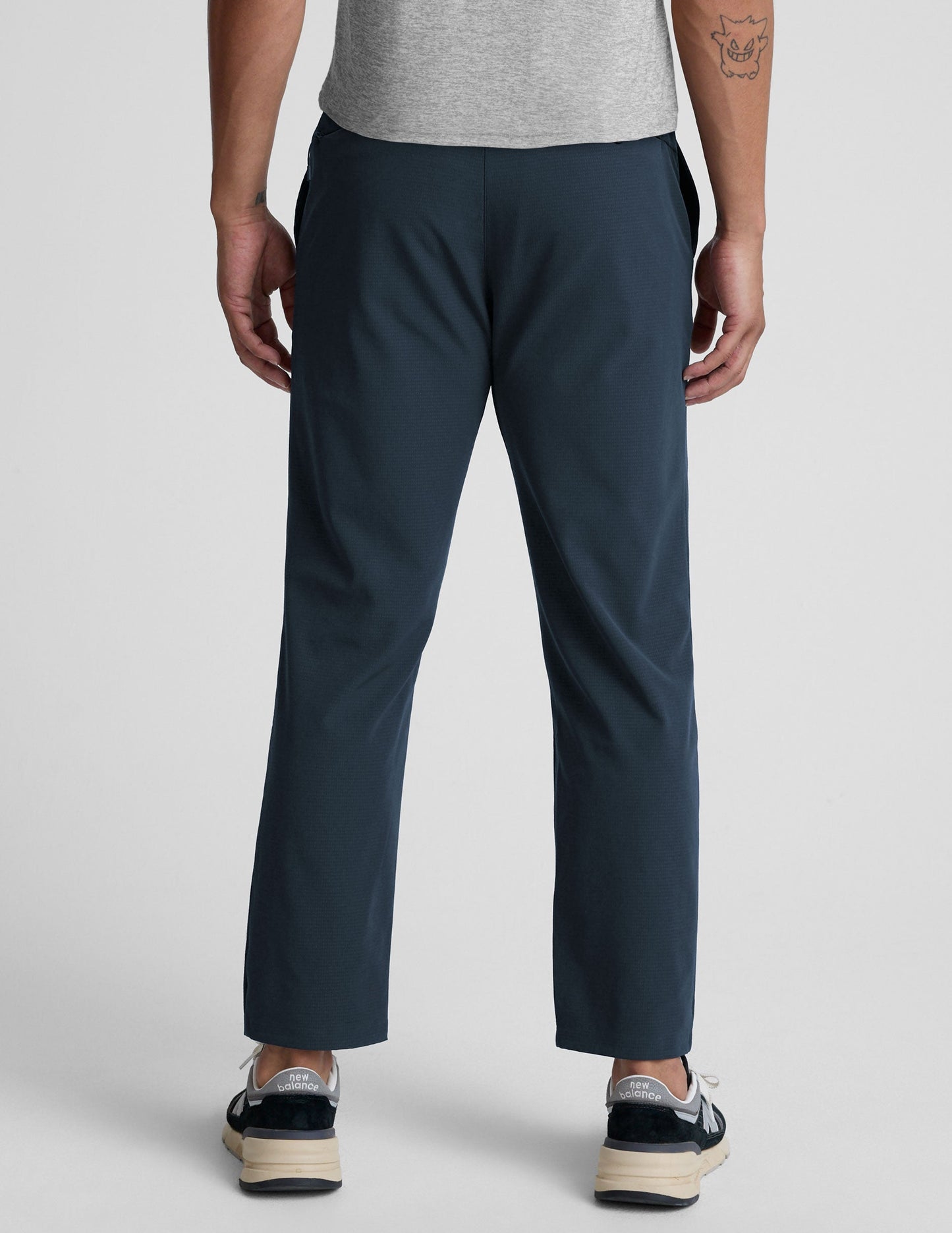 Rear view of the navy Dynamic Men's Straight Leg Pant featuring a relaxed fit and straight silhouette on a model.