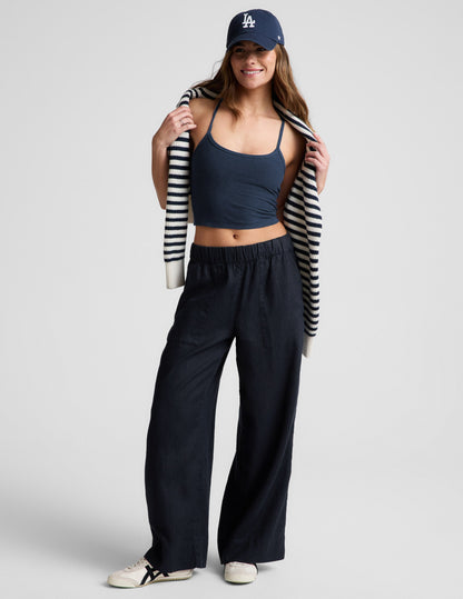 Model wearing SoftWash Linen Easy Wide Leg Pants in navy with a gathered elastic waistband, mid-rise fit, and front pockets.