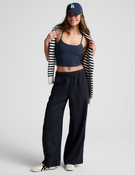 Model wearing SoftWash Linen Easy Wide Leg Pants in navy with a gathered elastic waistband, mid-rise fit, and front pockets.