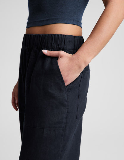 Side view of navy SoftWash Linen Easy Wide Leg Pant 29" showing the elastic waistband and hand in a front slant pocket.