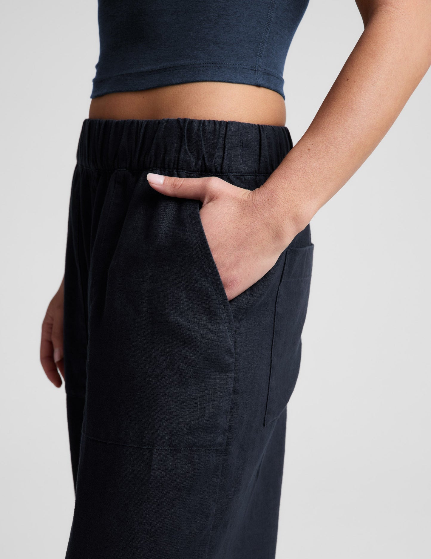 Side view of navy SoftWash Linen Easy Wide Leg Pant 29" showing the elastic waistband and hand in a front slant pocket.