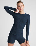 blue long sleeve crew neck top with thumb holes.