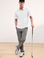 Element Men's Chino Trouser in gray, featuring a tailored straight-leg fit and worn by a man holding a golf club.