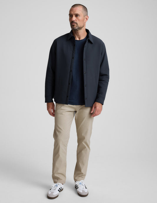 Man wearing cream Element Men's Chino Trouser 32", featuring a tailored straight-leg fit and side pockets.