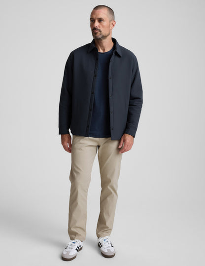 Man wearing cream Element Men's Chino Trouser 32", featuring a tailored straight-leg fit and side pockets.