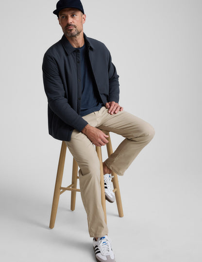 Element Men's Chino Trouser 32" in cream with a straight leg, modeled by a man sitting on a wooden stool.