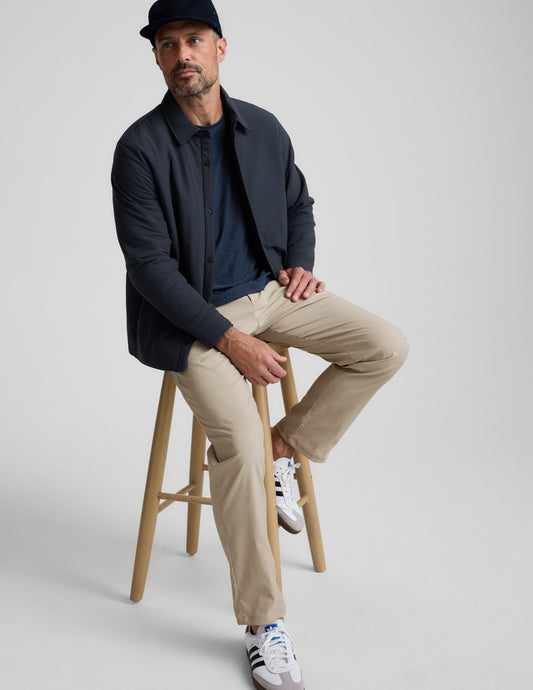 Element Men's Chino Trouser 32" in cream with a straight leg, modeled by a man sitting on a wooden stool.