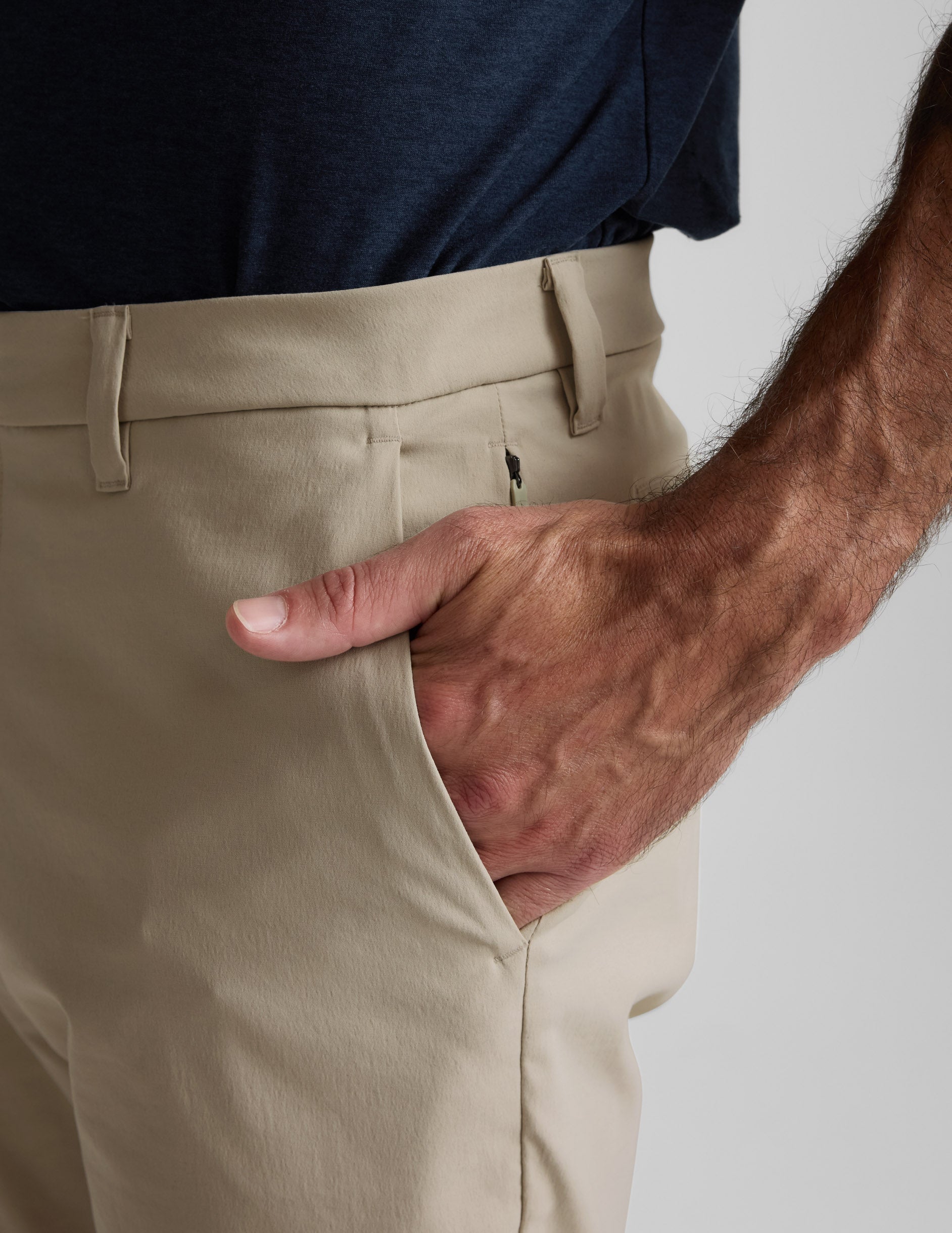 Close-up of cream Element Men's Chino Trouser showing side pocket with hand, belt loops, and hidden zipper pocket.