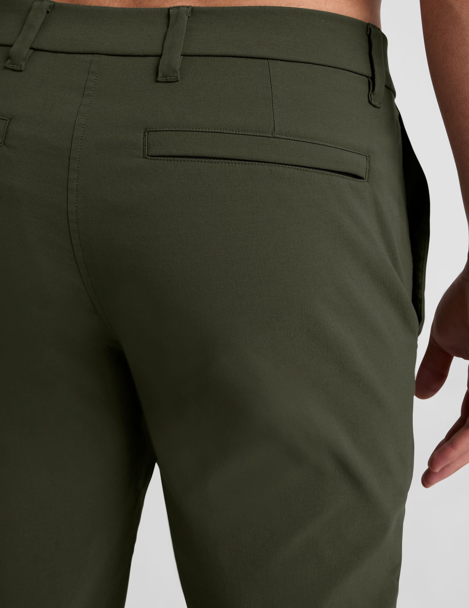 Rear view of olive green Essential Men's Chino 30" Trouser highlighting the waistband, belt loops, and welt pocket.
