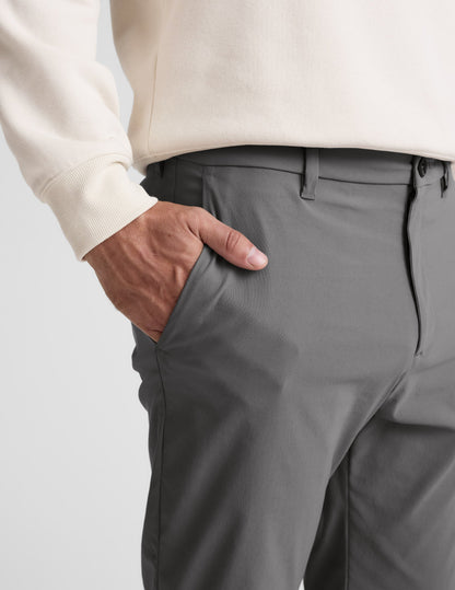 Close-up of gray Element Men's Chino Trouser showing a hand in the side slant pocket, waistband, and belt loops.
