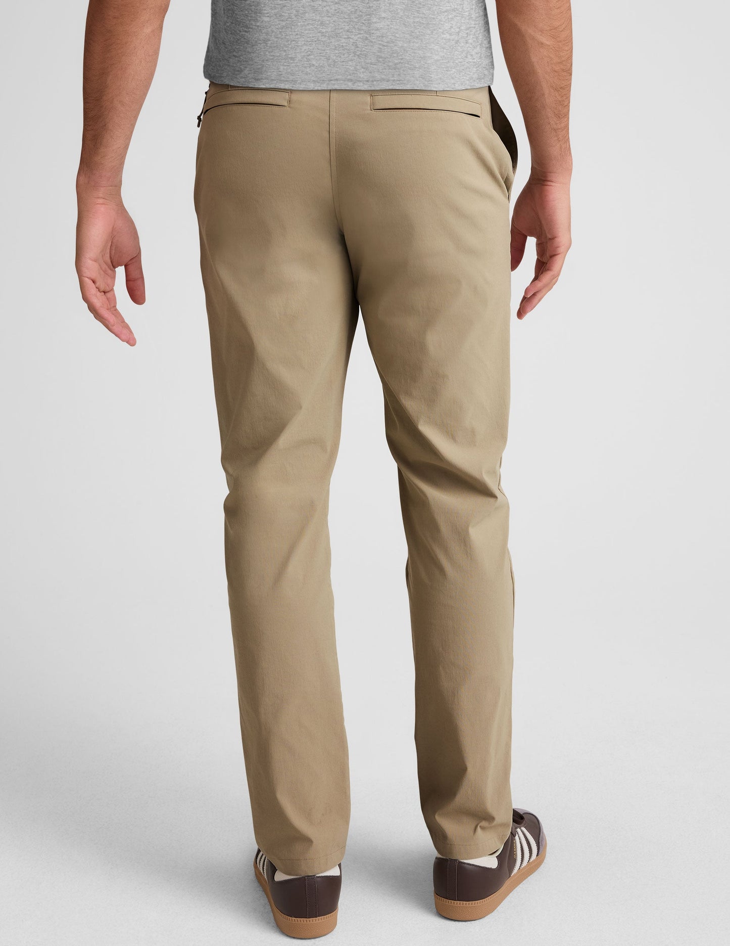 Rear view of the beige Essential Men's Chino 32" Trouser, showing the straight-leg fit, belt loops, and welt back pockets.