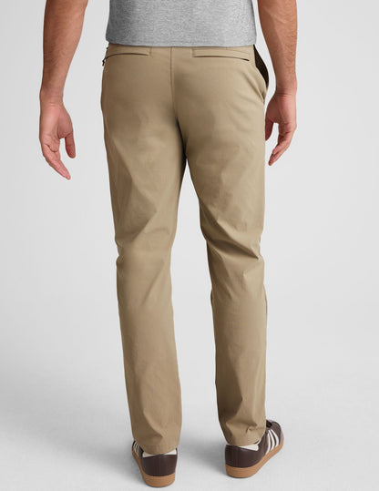 Rear view of the beige Essential Men's Chino 32" Trouser, showing the straight-leg fit, belt loops, and welt back pockets.