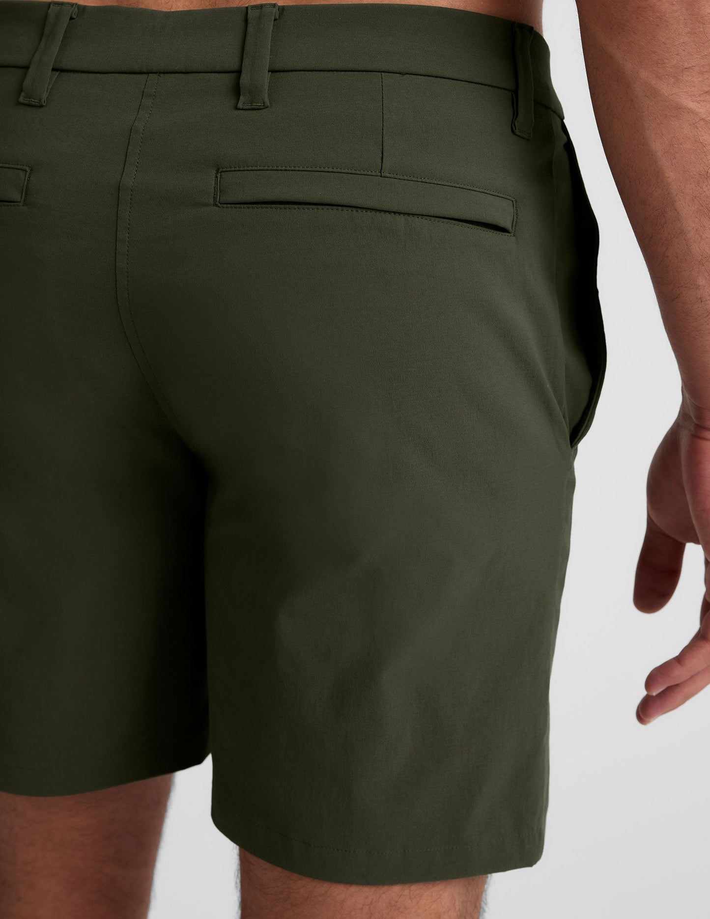 Rear view of olive Essential Men's Chino 7" Short featuring a back welt pocket and belt loops in a tailored fit.