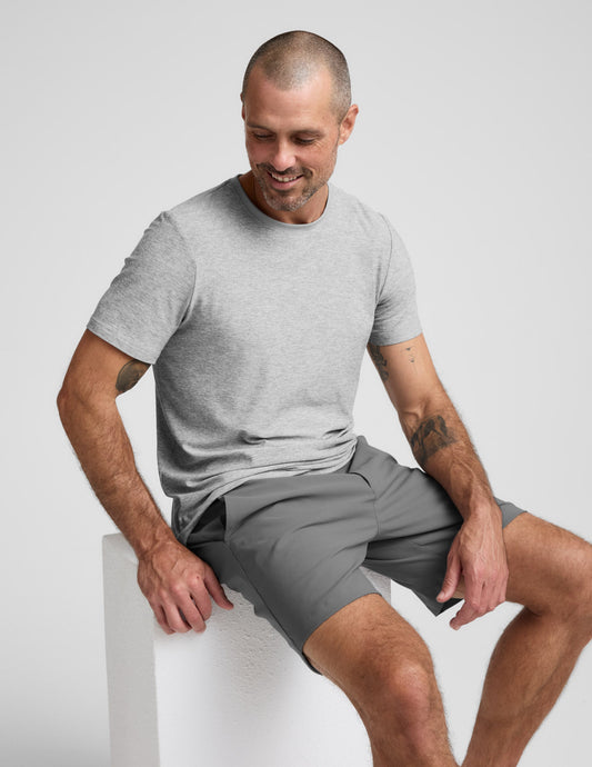 Man sitting in dark gray Element Men's Chino Short 7" and light gray tee. Mid-thigh length with a tailored, casual fit.