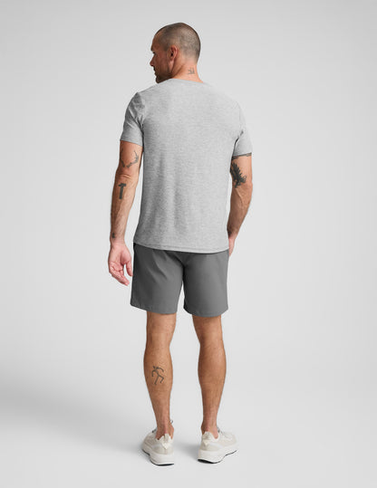 Back view of dark gray Element Men's Chino Short 7" on a man, paired with a light gray t-shirt and white sneakers.