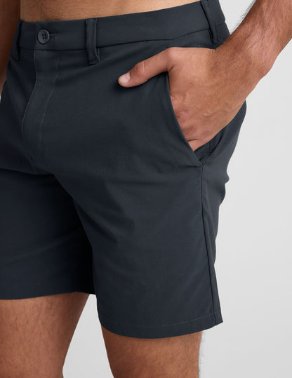 Close-up of the dark gray Essential Men's Chino 7" Short showing the side pocket, belt loops, and button closure.