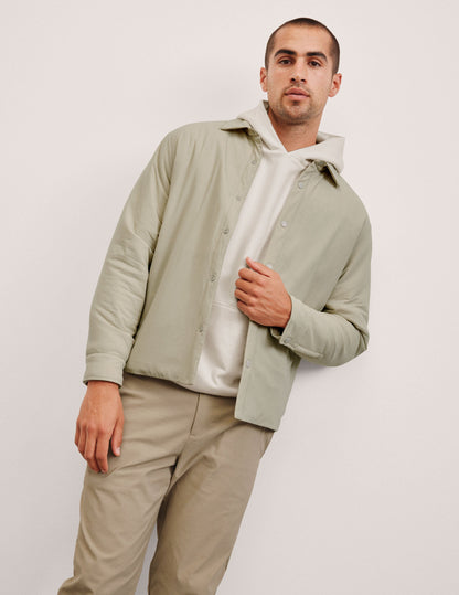brown men's button up insulated jacket with a shirt collar and side seam invisible zipper pockets.
