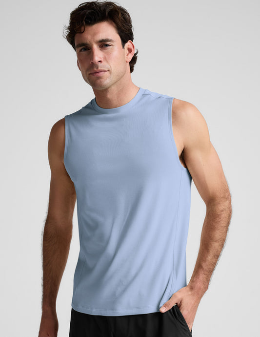 Man wearing a blue tank and black shorts against a plain background.