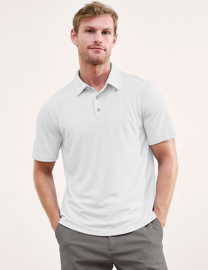 Man wearing a white polo shirt and gray pants on a plain background.