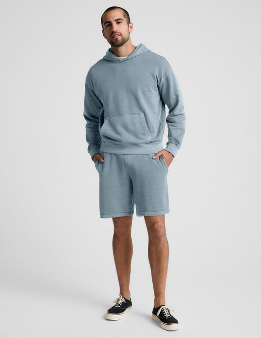 Man wearing Blue Beach Washed Terry Men's Short paired with a matching blue hoodie and black sneakers.