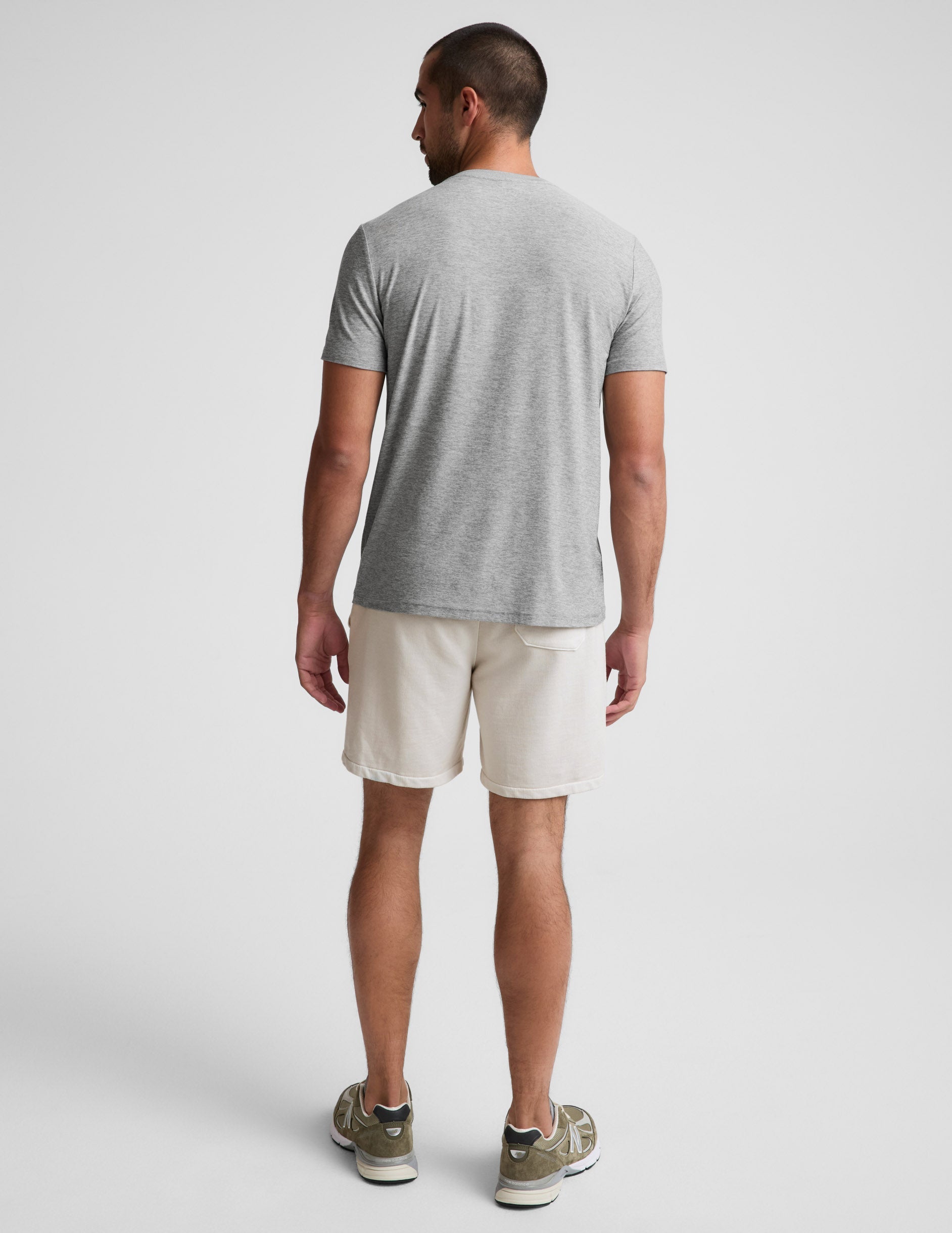 Man wearing Cream Beach Washed Terry™ Men's Short, rear view, paired with a grey t-shirt and sneakers.
