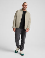 Smiling man wearing the gray Classic Fleece Men's Jogger, featuring a relaxed fit and elastic cuffs, walking forward.