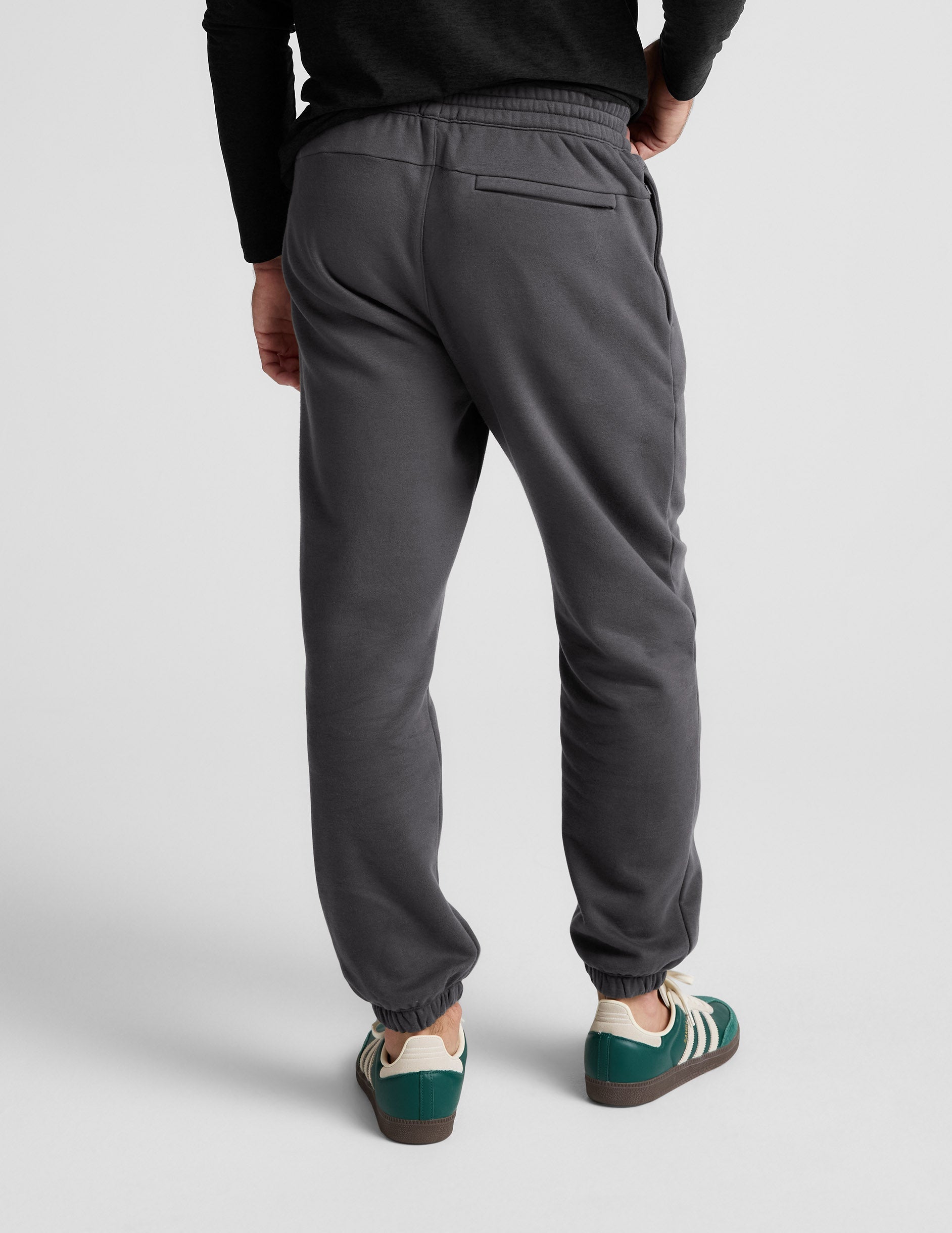 Rear view of gray Classic Fleece Men's Jogger featuring a relaxed fit, elastic waistband, and zippered back welt pocket.