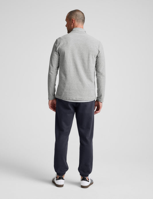 Rear view of a man wearing the Classic Fleece Men's Jogger in dark gray, featuring a relaxed fit and elasticated cuffs.