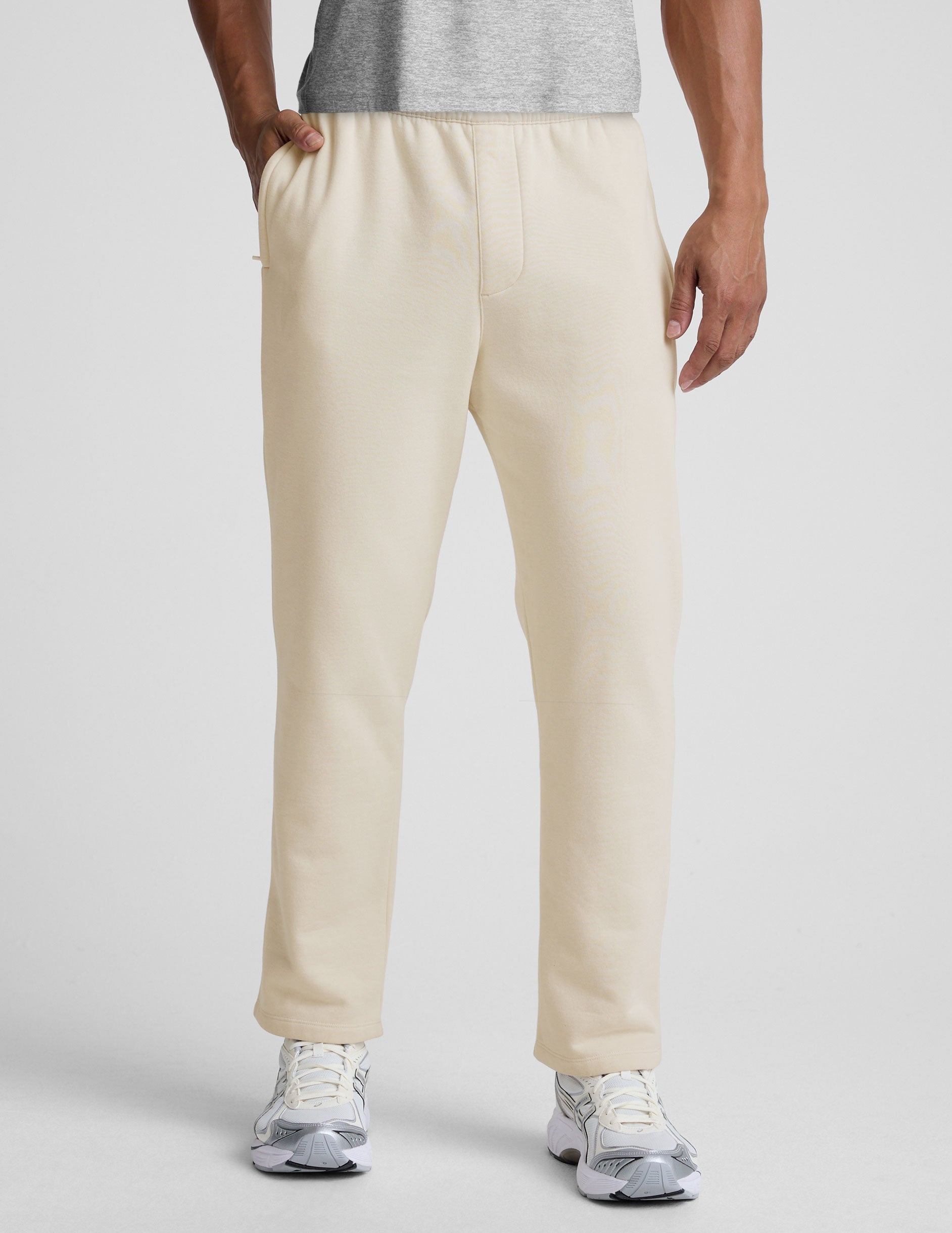 Front view of cream LuxeFleece Men's Straight Leg Pant with a relaxed fit and elastic waistband, worn with white sneakers.