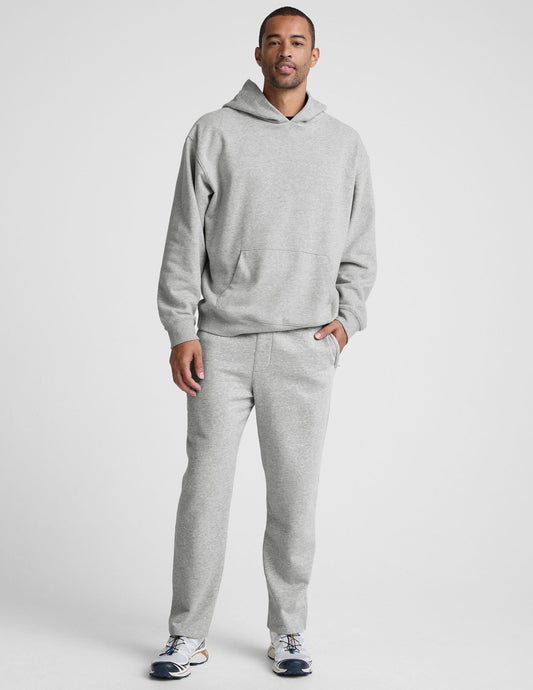 Man wearing gray marled LuxeFleece Men's Straight Leg Pant. Relaxed fit fleece pants with zipper pockets and straight leg.
