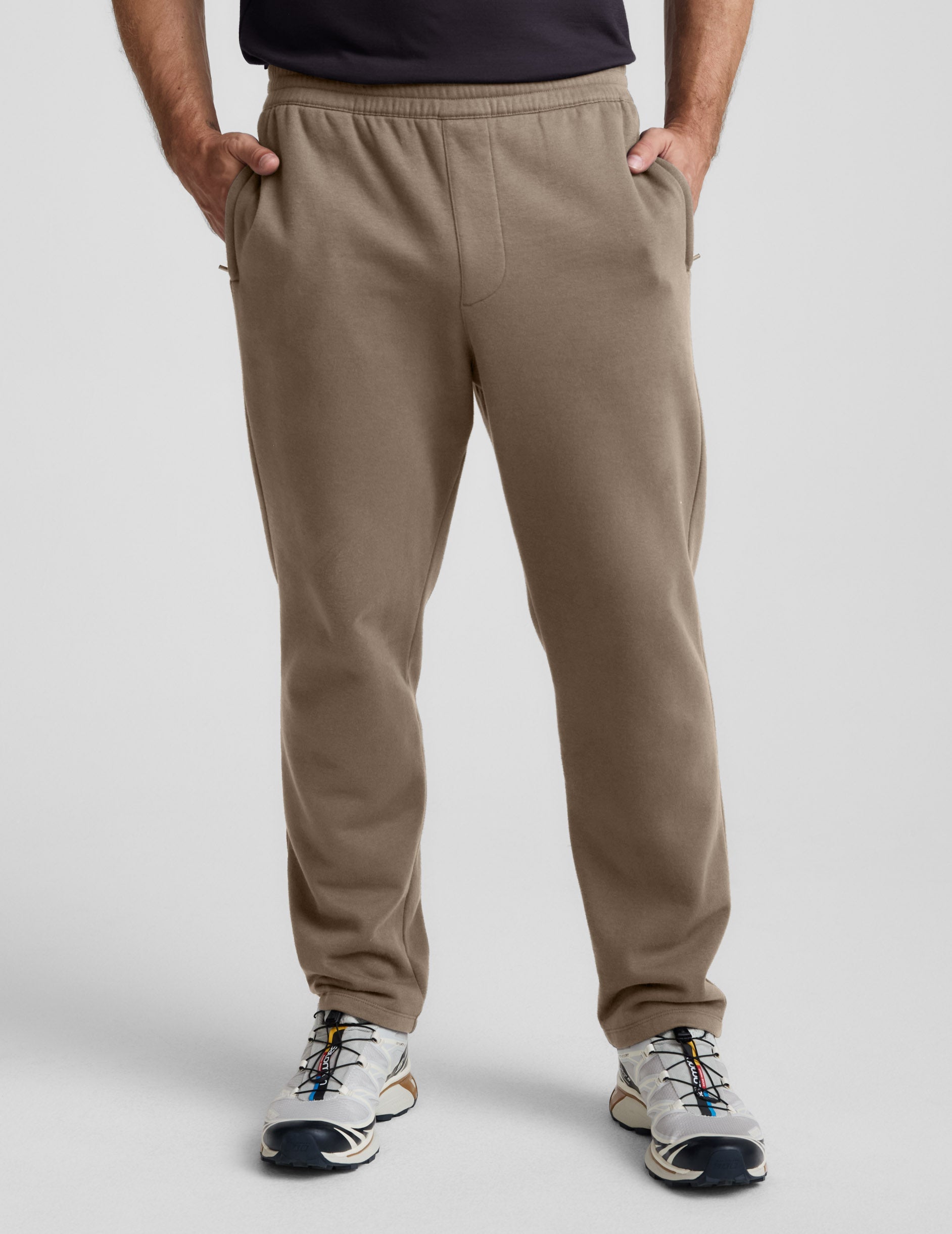 LuxeFleece Men's Straight Leg Pant in brown with an elastic waistband and side zipper pockets, shown on a model.