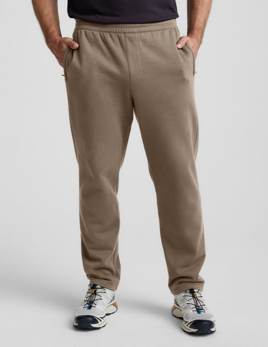 LuxeFleece Men's Straight Leg Pant in brown with an elastic waistband and side zipper pockets, shown on a model.