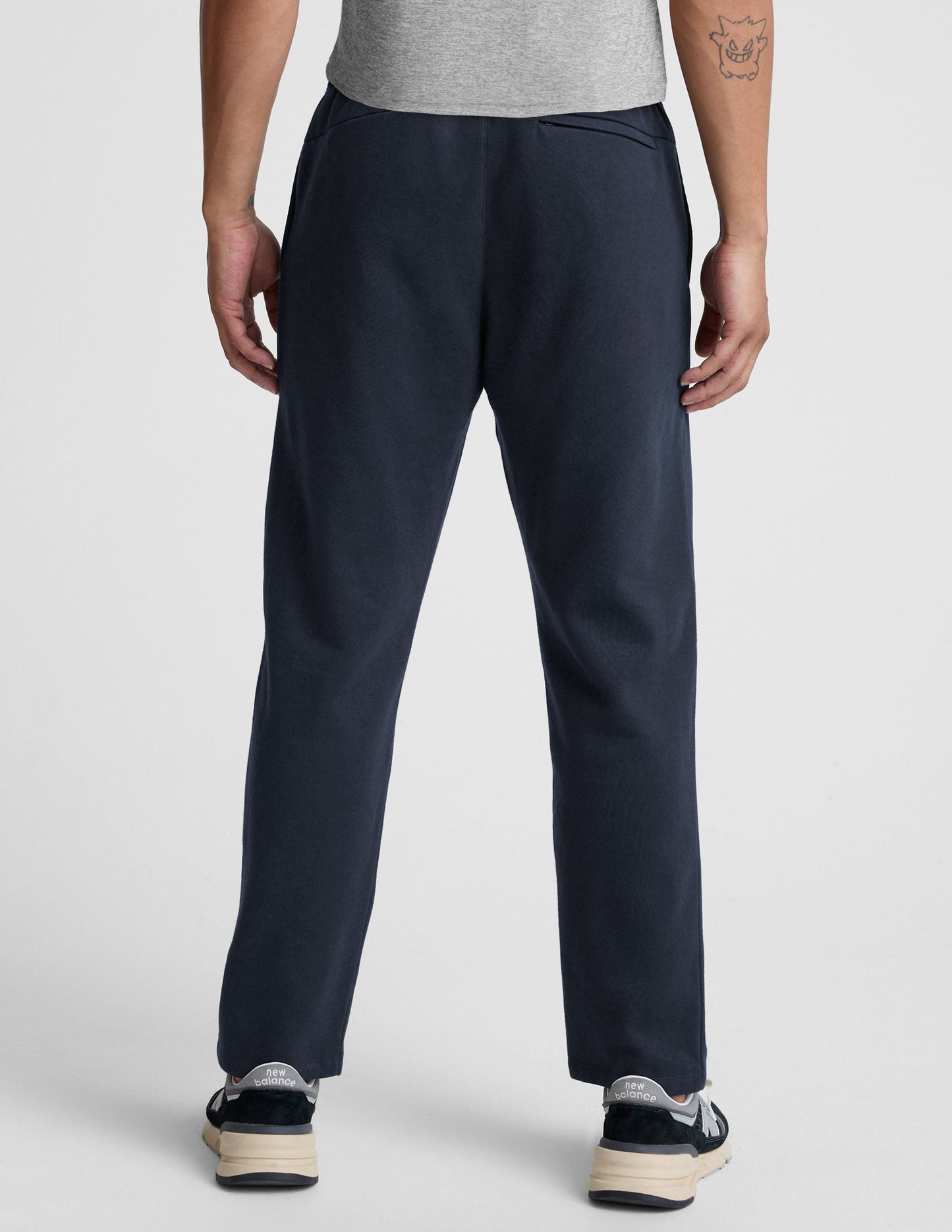 Rear view of navy LuxeFleece Men's Straight Leg Pant showing the relaxed straight leg fit and zippered pocket detail.