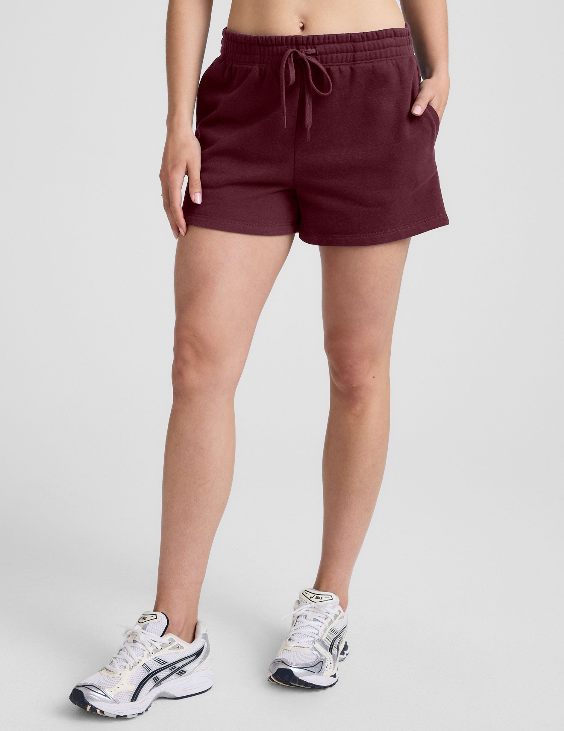 Maroon LuxeFleece Sweat Short featuring an elastic drawstring waistband and side pockets, shown on a model.