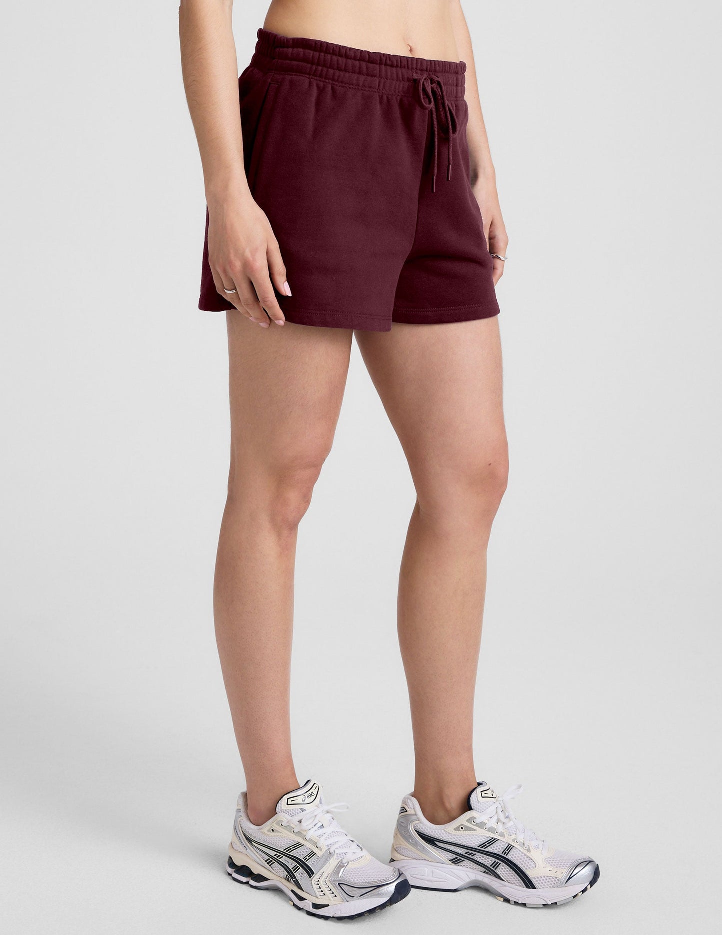 Maroon LuxeFleece Sweat Short with a drawstring elastic waistband and relaxed fit, hitting above mid-thigh on a model.