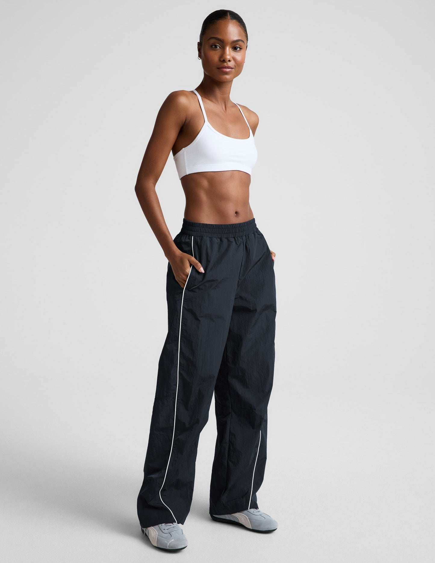 Limitless Mid-Rise Barrel Leg Pant in dark gray featuring white side piping, elastic waistband, and a roomy silhouette.