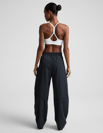 Back view of the Limitless Mid-Rise Barrel Leg Pant in dark gray, showing its gathered waist and wide barrel-leg fit.