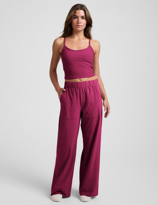 Woman wearing Maroon Beyond Yoga™ Easy Wide Leg Pant 31" paired with a matching tank top and sneakers.