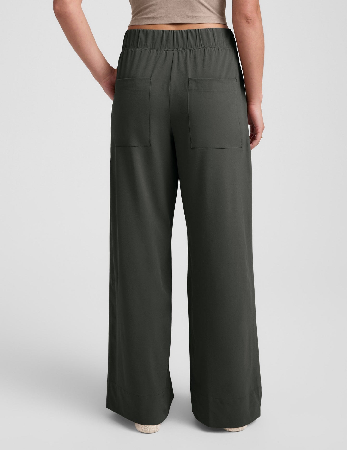 Back view of Easy Wide Leg Pant 31" in dark olive, showing its elastic waist, back pockets, and relaxed wide leg silhouette.