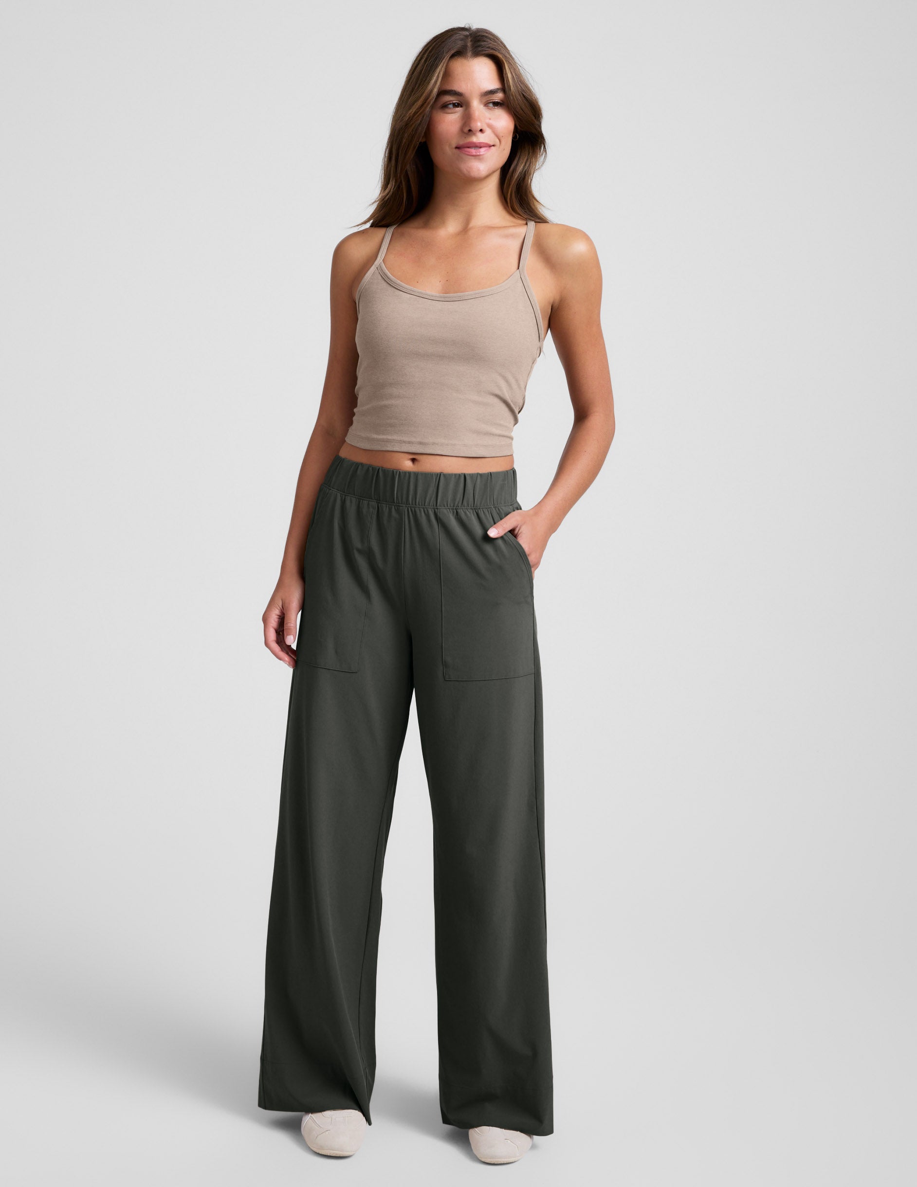 Woman in dark green Easy Wide Leg Pant 31" featuring an elastic waist and large front pockets with a relaxed, flowy fit.