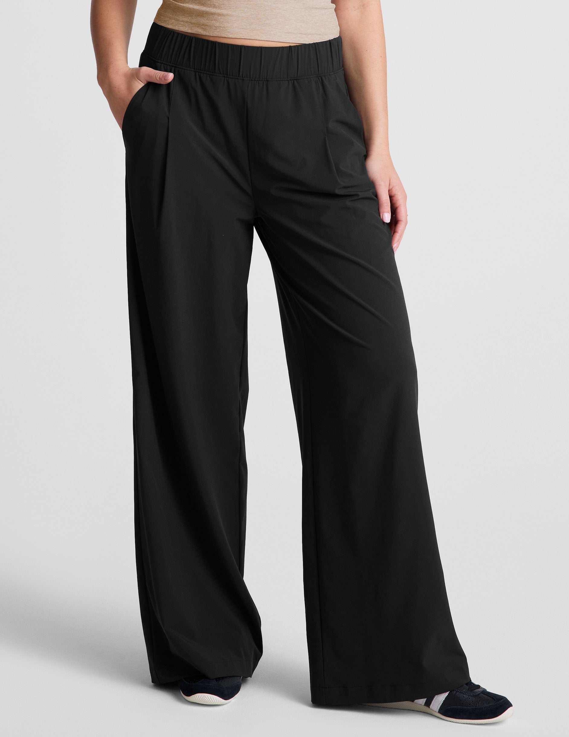 Black Easy Wide Leg 29" Pant featuring a gathered elastic waistband, front pleats, and side pockets on a model.
