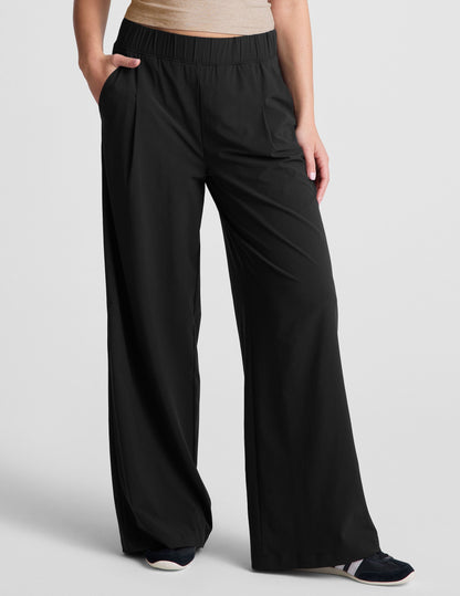 Black Easy Wide Leg 29" Pant featuring a gathered elastic waistband, front pleats, and side pockets on a model.