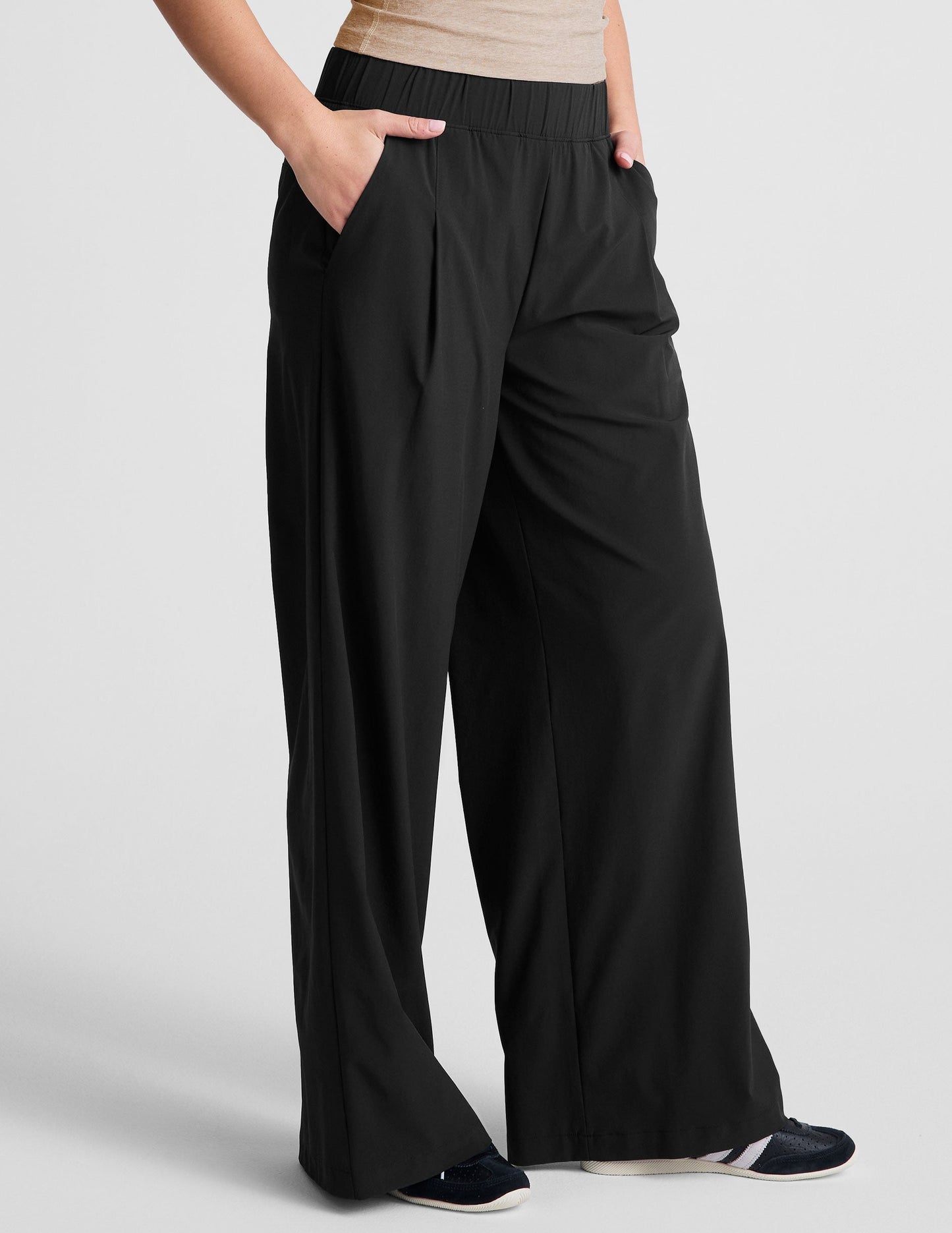 Black Easy Wide Leg 29" Pant with elastic waist, front pleats and side pockets shown in a flowy, relaxed fit on a model.