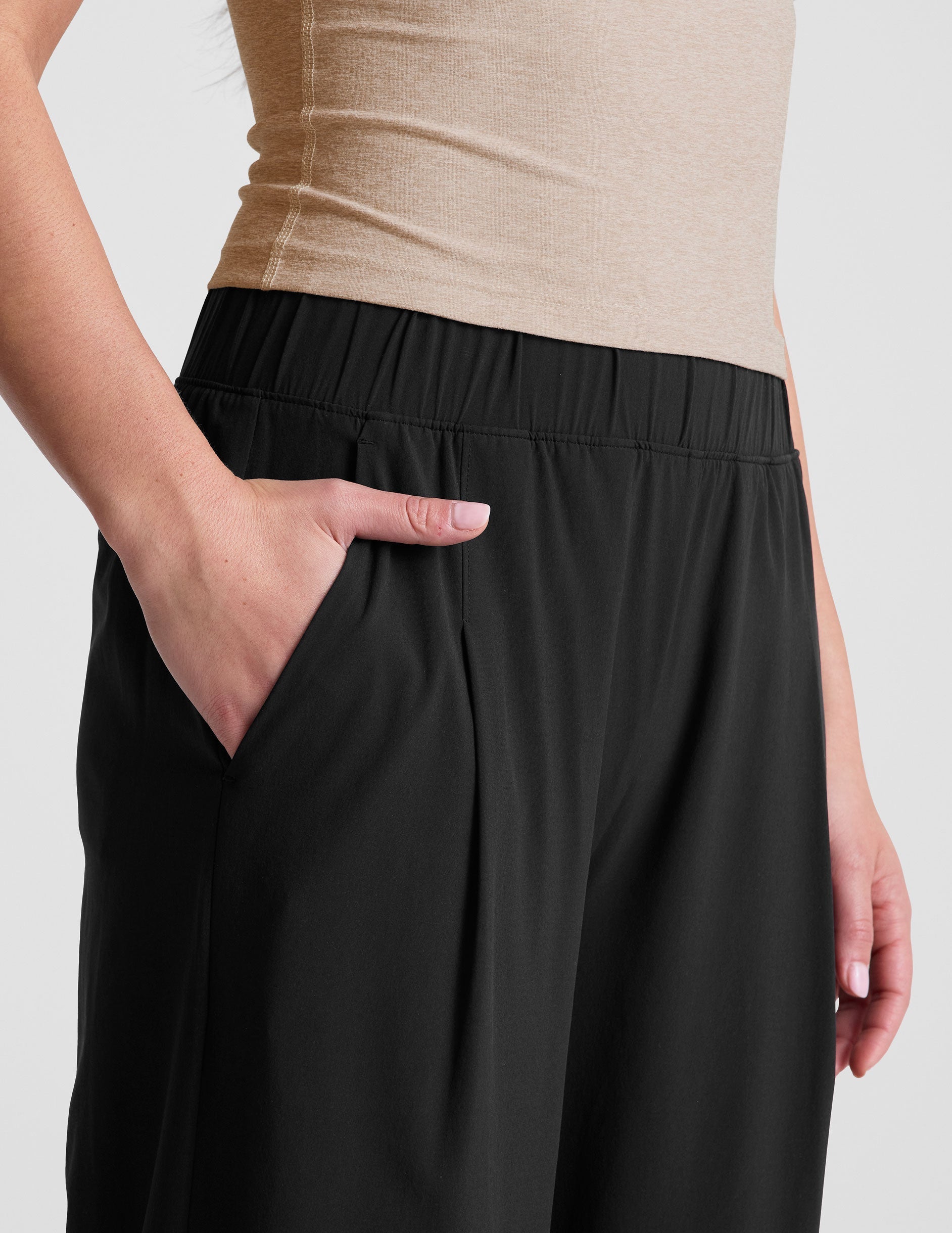 Close-up of black Easy Wide Leg 29" Pant showing the gathered elastic waistband and side slant pocket.