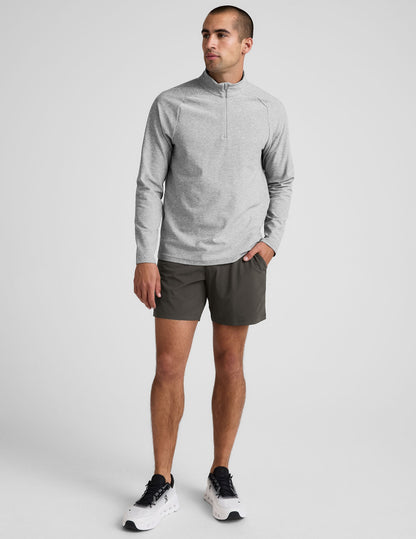 Man wearing dark gray Pivotal 2.0 Men's Lined Short 7" with a relaxed fit, mid-thigh length, and elastic waistband.