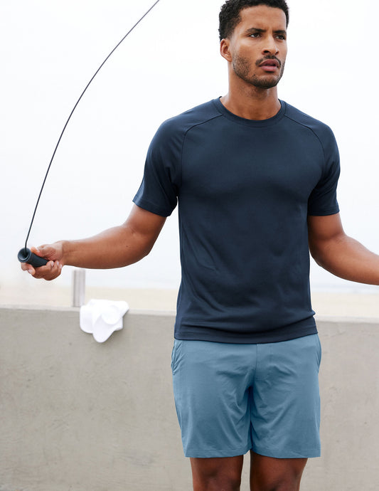 Man jumping rope outdoors in blue Pivotal 2.0 Men's Lined Short 7" with a relaxed fit and elastic waistband.