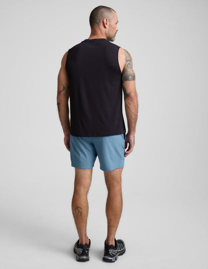 Rear view of a man in ice blue Pivotal 2.0 Men's Lined Short 7" with a relaxed fit and elastic waistband.