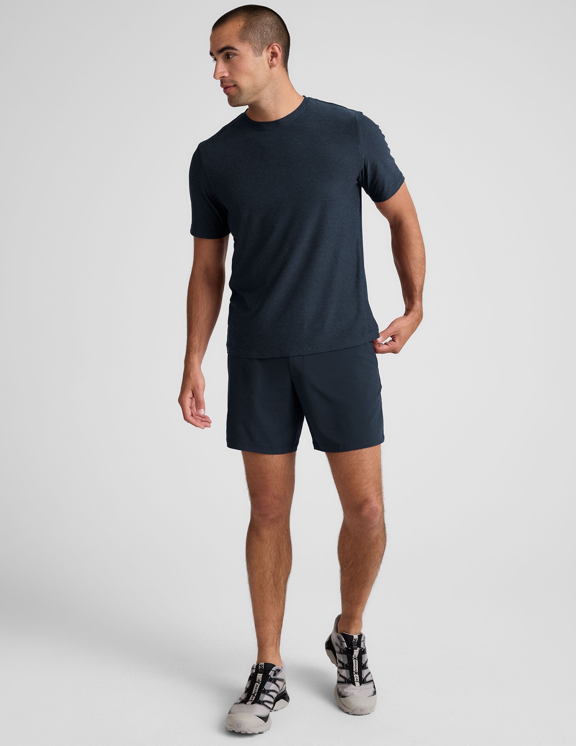 Navy Pivotal 2.0 Men's Lined Short 7" in navy on a model, featuring a relaxed fit, mid-thigh length, and elastic waistband.